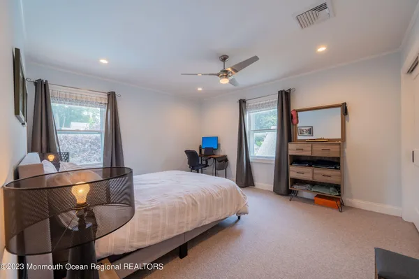 a bedroom with a bed and a view of kitchen