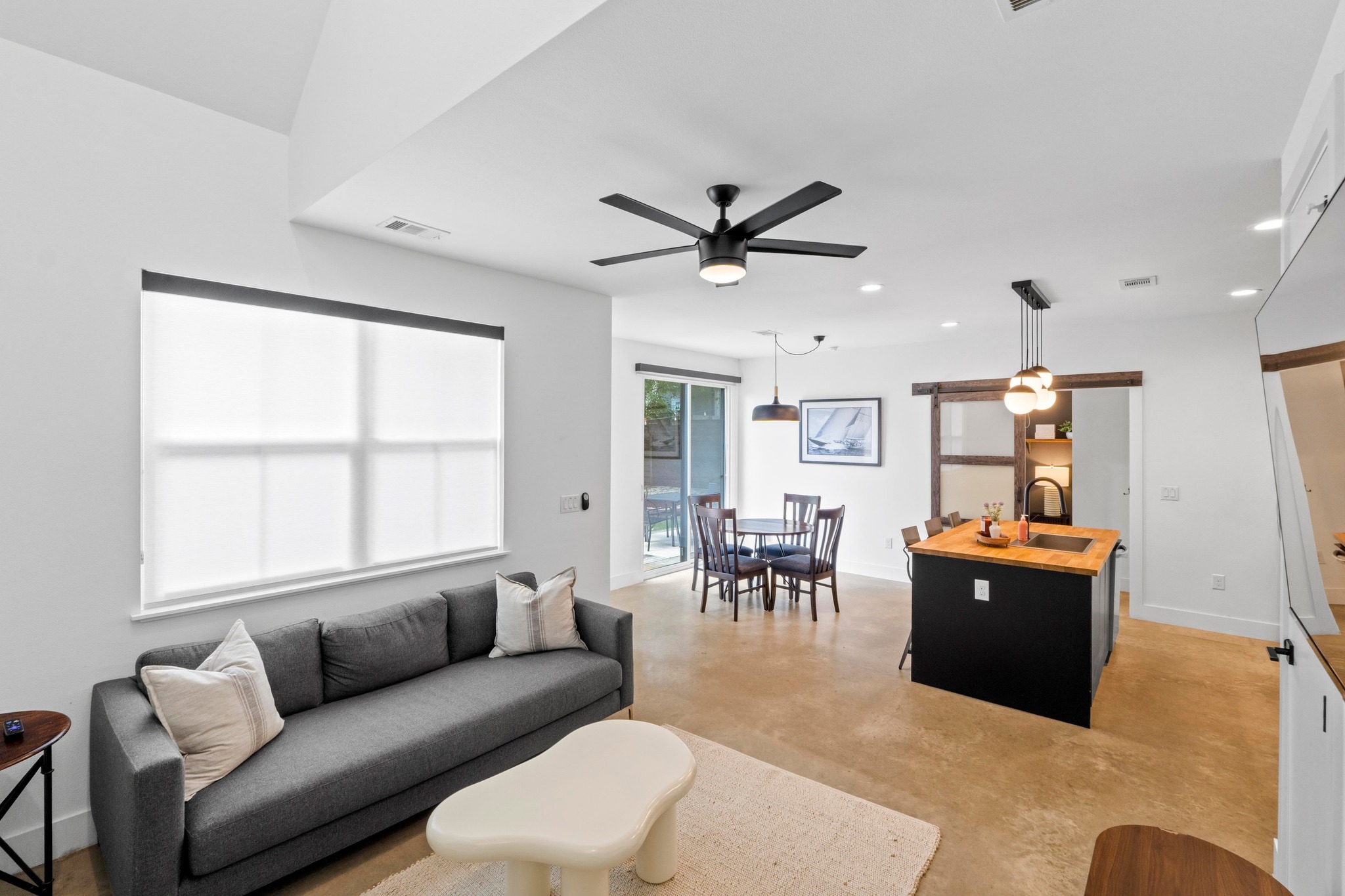 1706 Perez Street, Unit 2 Austin, TX 78721 - Photo 6 of 29 A naturally illuminated living area and kitchen with high ceilings and sleek flooring.
