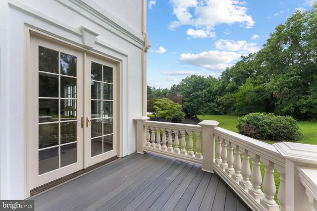 a view of a patio with table and chairs with wooden floor and fence