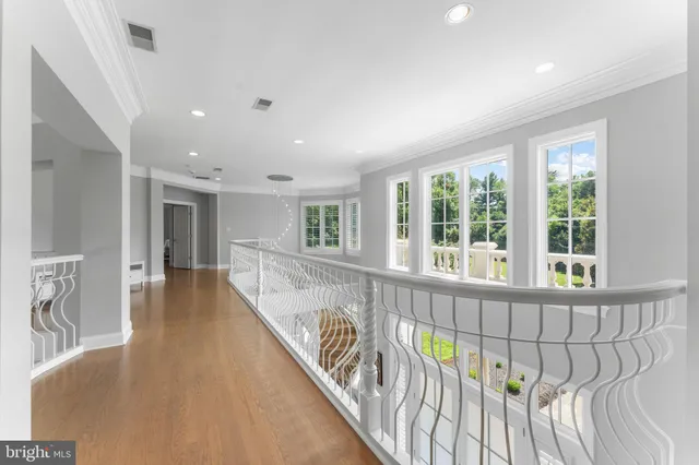 a view of a big house with a big yard and large trees