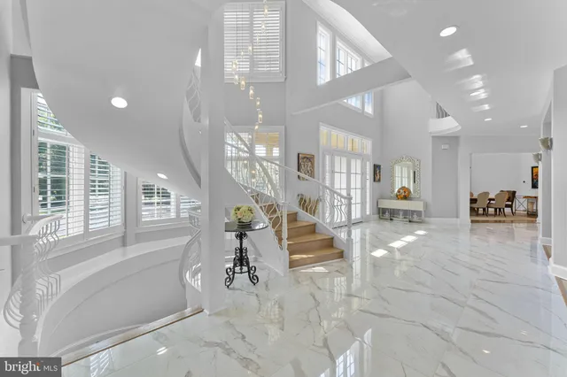 a large white kitchen with a large window and stainless steel appliances