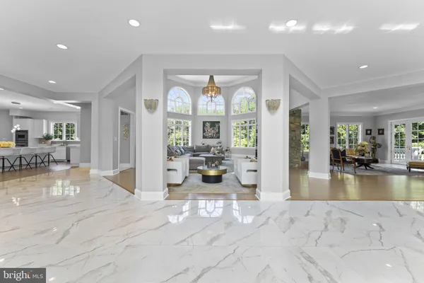 a kitchen with stainless steel appliances granite countertop a sink a stove and a wooden floors