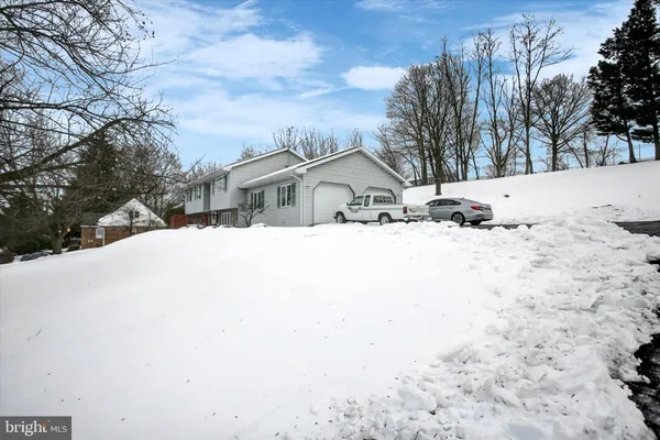 a view of snow on the side of a road