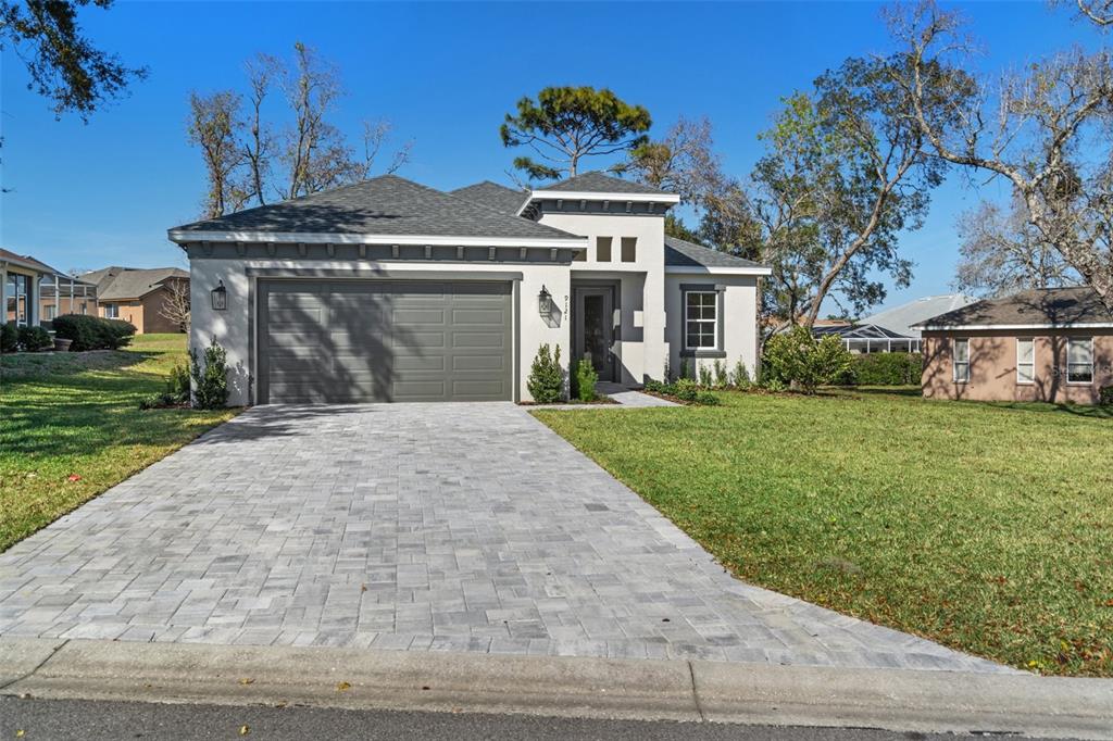 9121 Tarleton Circle Weeki Wachee, FL 34613 - Photo 1 of 1 a front view of a house with a yard and garage