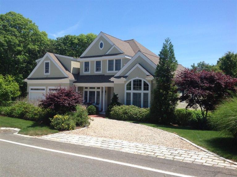 76 Greensward Road Mashpee, MA 02649 - Photo 1 of 24 a front view of a house with a yard