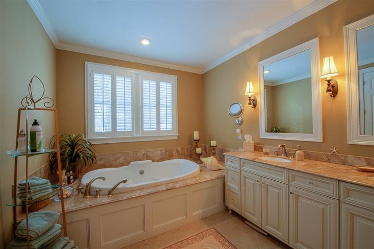76 Greensward Road Mashpee, MA 02649 - Photo 17 of 24 a bathroom with a tub sink and mirror