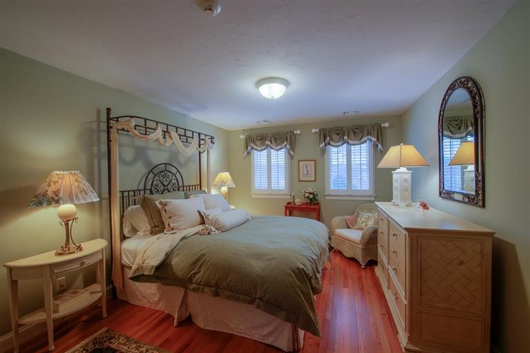 76 Greensward Road Mashpee, MA 02649 - Photo 23 of 24 a bedroom with a bed and wooden floor