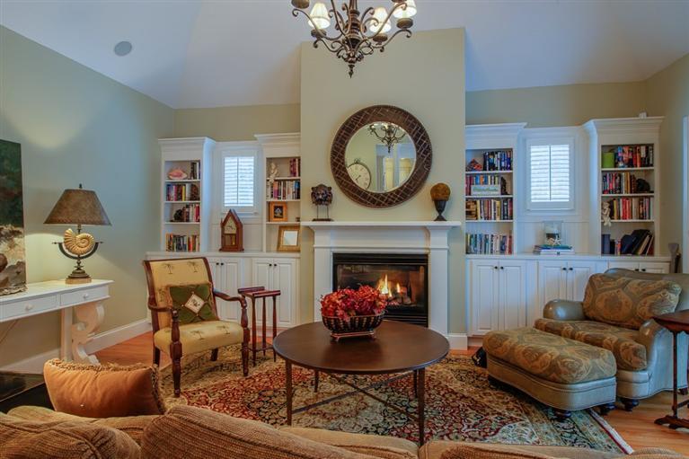 76 Greensward Road Mashpee, MA 02649 - Photo 7 of 24 a living room with furniture a clock and a fireplace