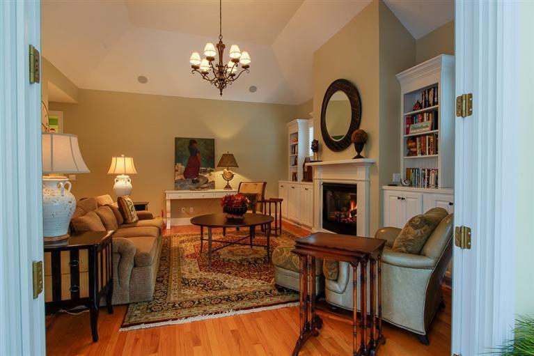 76 Greensward Road Mashpee, MA 02649 - Photo 8 of 24 a living room with furniture a fireplace and a chandelier