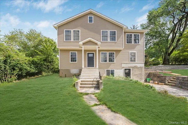 a front view of a house with a yard
