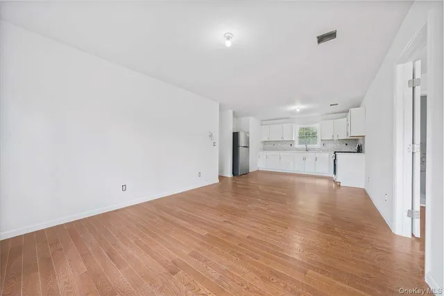 a view of a kitchen with a sink and wooden floor