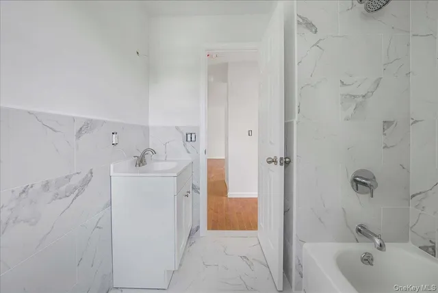a bathroom with a sink a mirror and a bathtub
