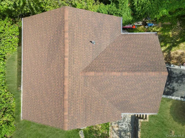 an aerial view of a house with yard