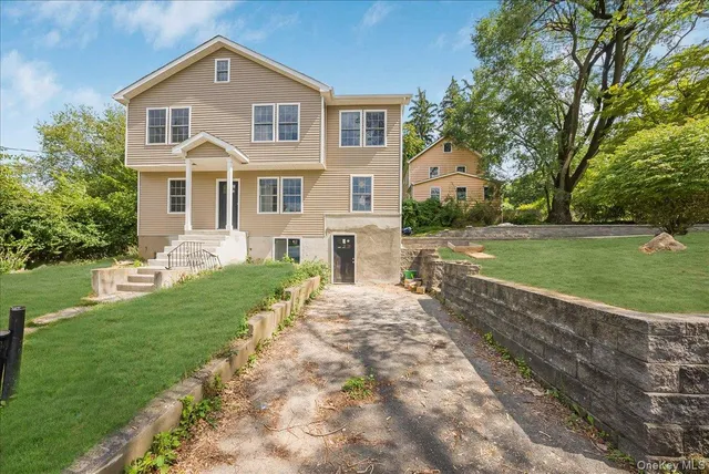 a white house covered with tall trees