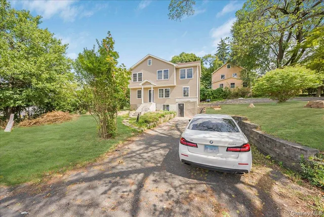 a couple of cars parked in front of a house