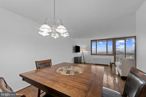 a view of a dining room with furniture wooden floor and chandelier
