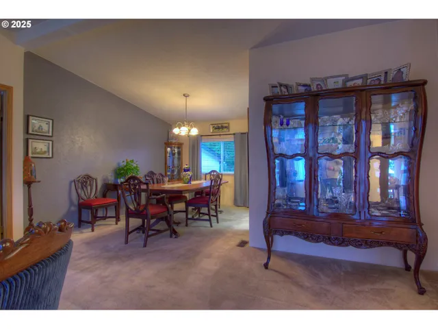 a view of a dining room with furniture and chandelier