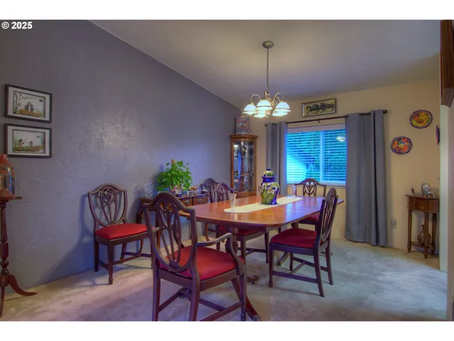 a view of a dining room with furniture and chandelier