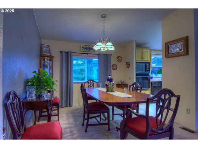 a view of a dining room with furniture and chandelier