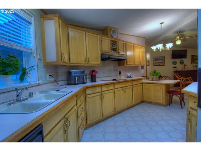 a kitchen with a sink cabinets and window