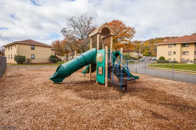 a view of a park with swings and slides