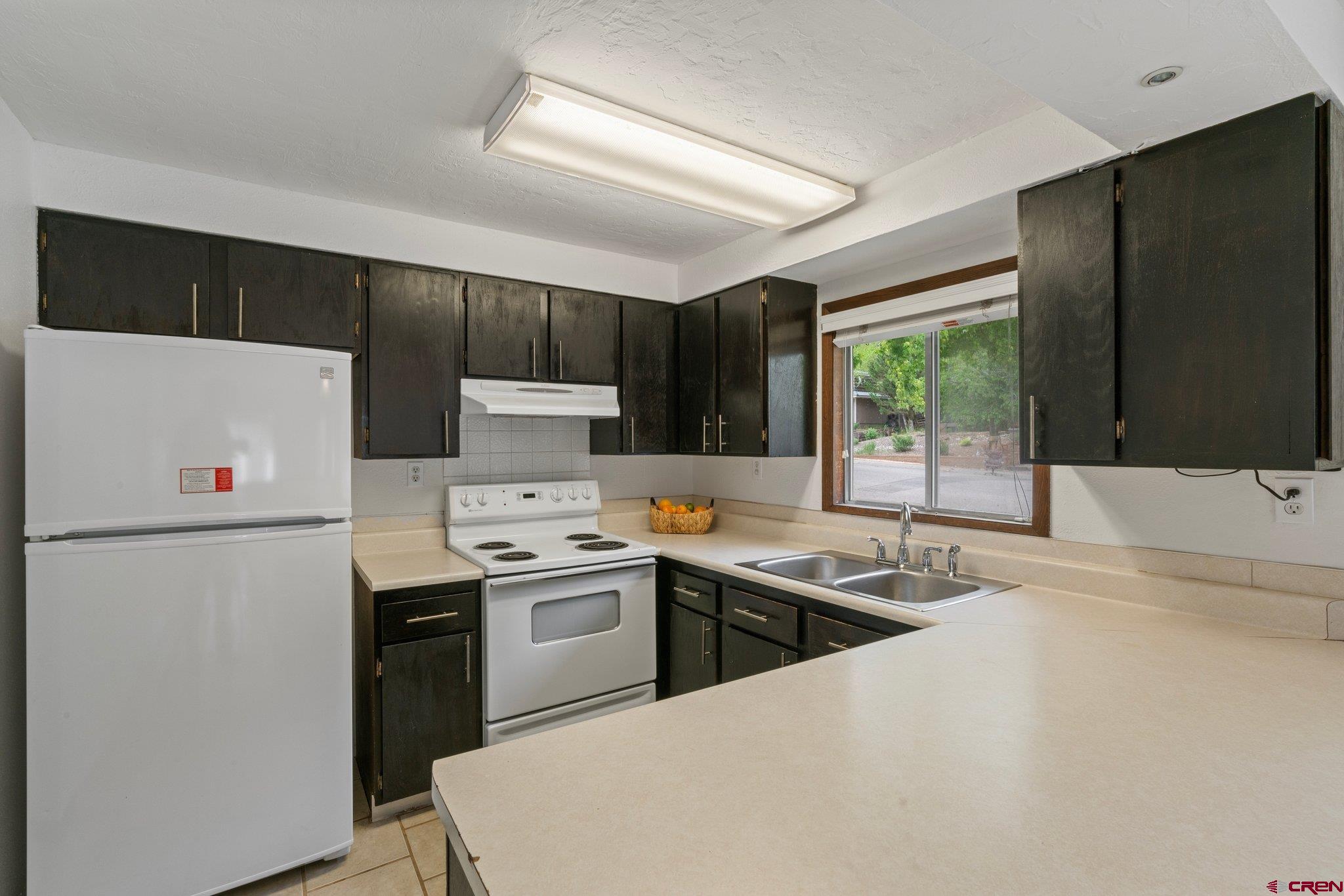 2913 Richard Drive Durango, CO 81301 - Photo 12 of 35 a kitchen that has a sink a stove and a refrigerator
