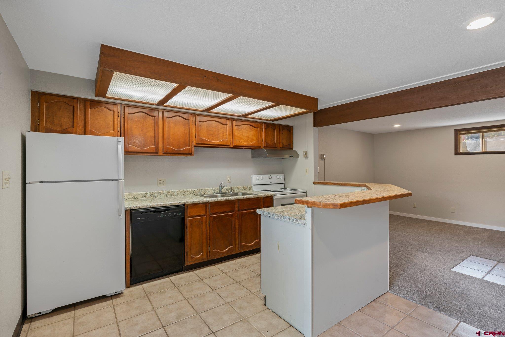 2913 Richard Drive Durango, CO 81301 - Photo 23 of 35 a kitchen with stainless steel appliances granite countertop a stove a refrigerator and a sink