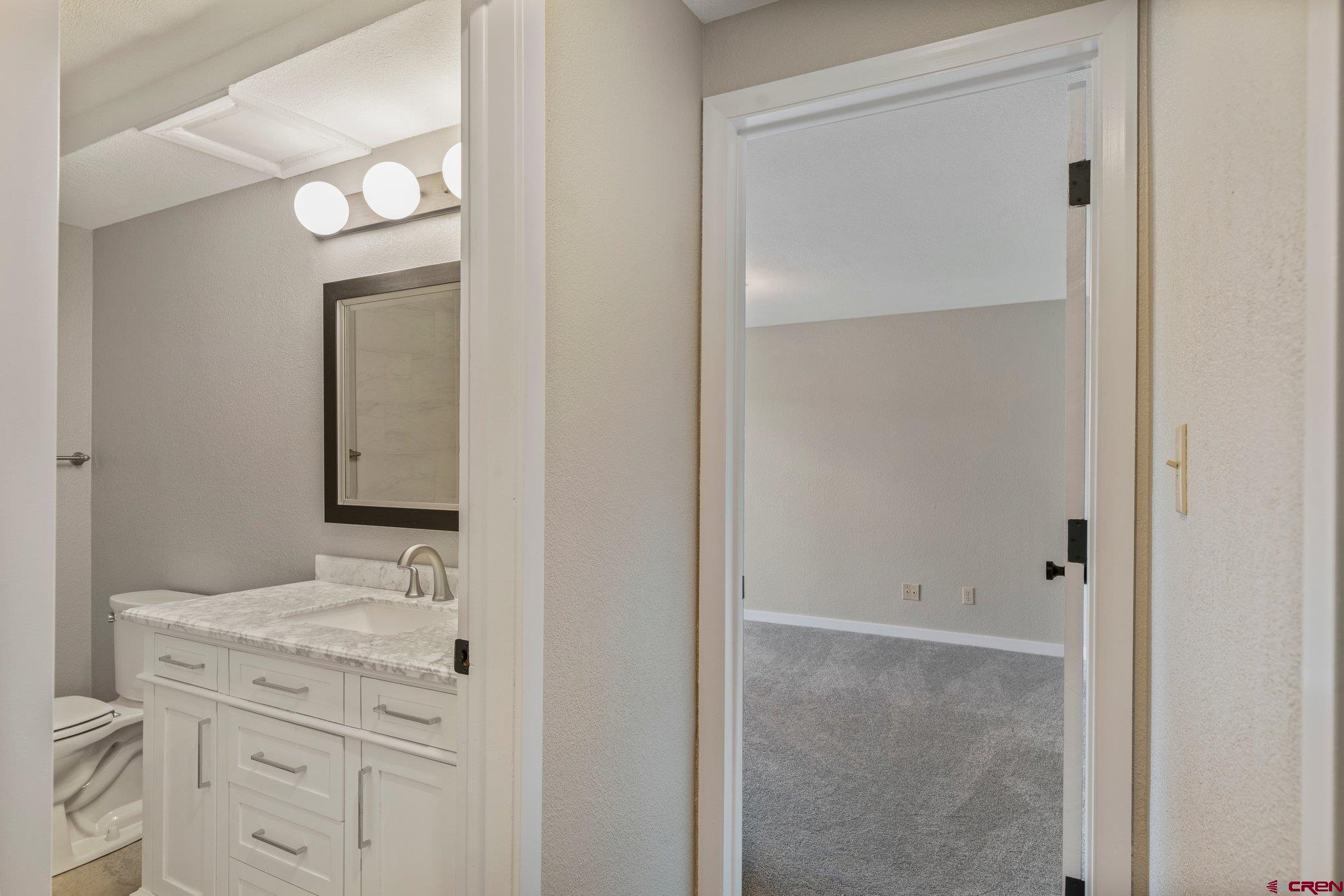 2913 Richard Drive Durango, CO 81301 - Photo 31 of 35 a bathroom with a granite countertop sink and a mirror