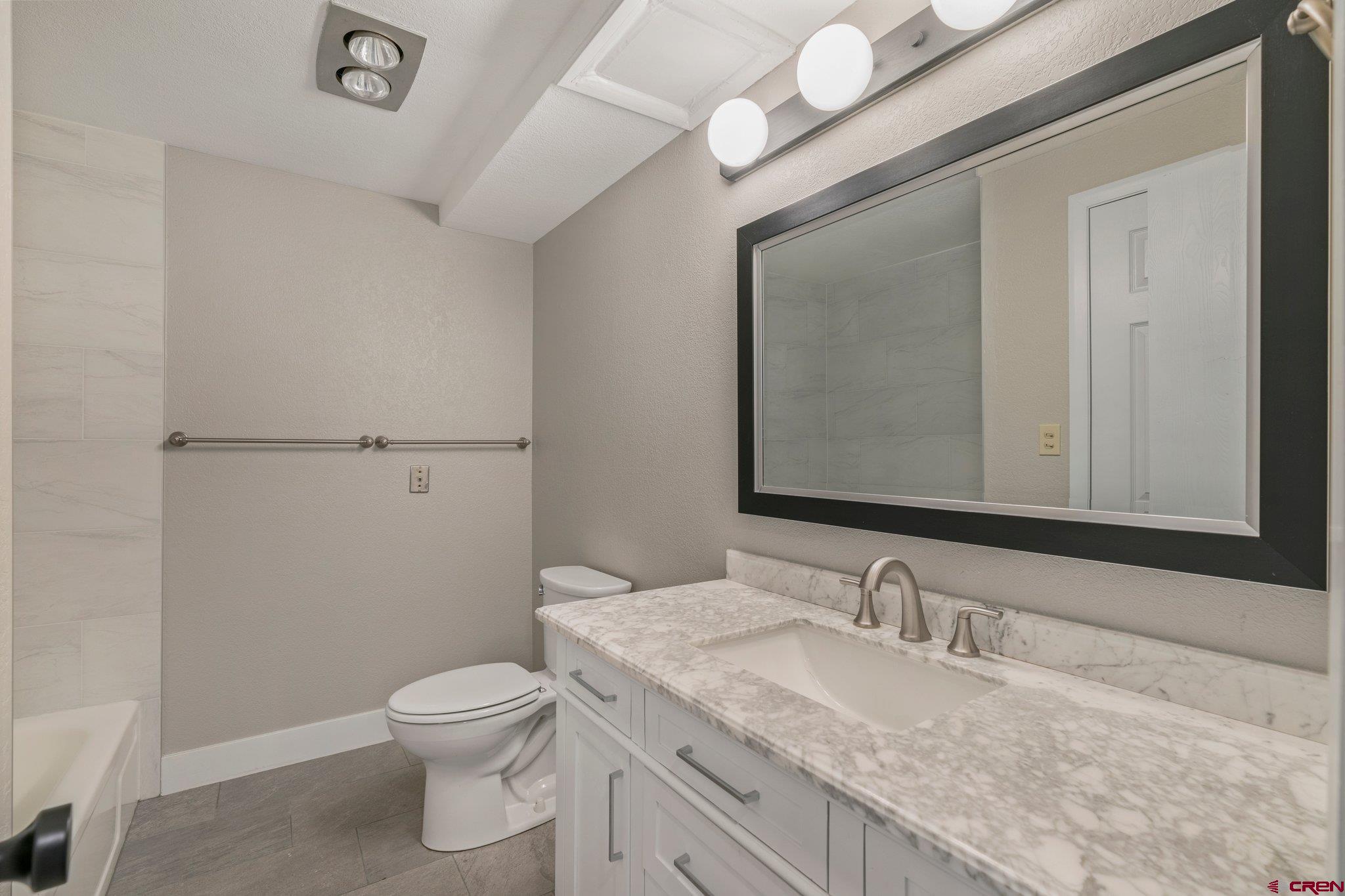2913 Richard Drive Durango, CO 81301 - Photo 32 of 35 a bathroom with a granite countertop toilet sink and mirror
