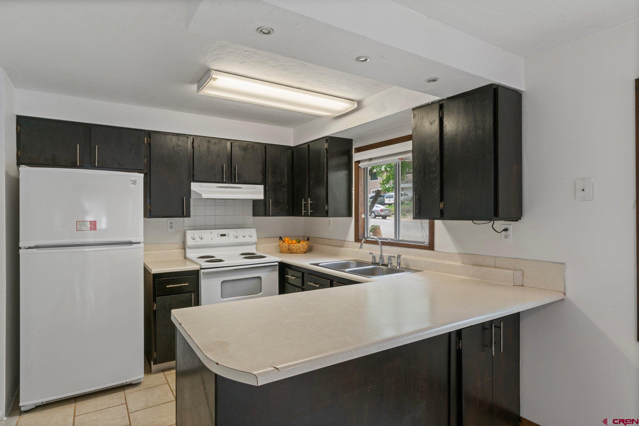 2913 Richard Drive Durango, CO 81301 - Photo 8 of 35 a kitchen that has a sink a stove and a refrigerator