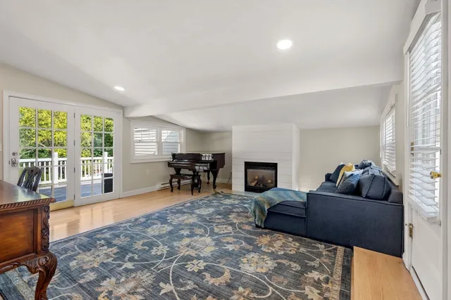 a living room with fireplace furniture and a flat screen tv