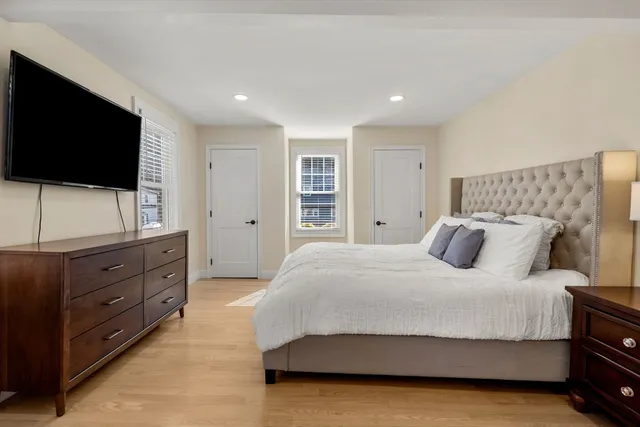 a bedroom with a large bed and a flat screen tv