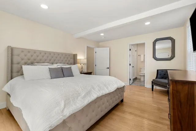 a bedroom with bed and a desk