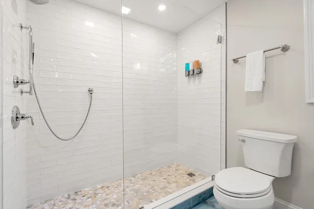 a bathroom with a toilet and a shower