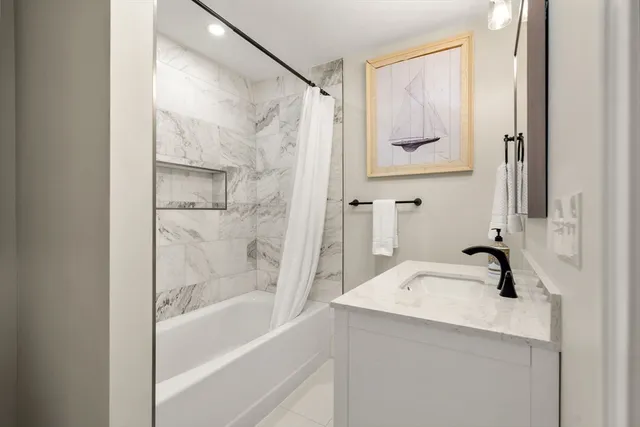 a bathroom with a tub and a sink