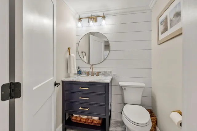 a bathroom with a toilet a sink and mirror