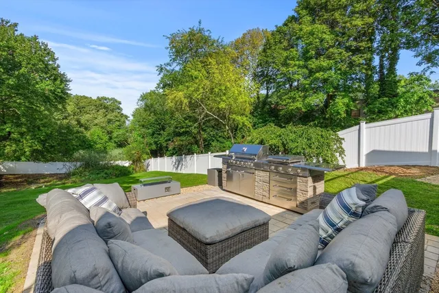 a view of a patio with couches and a fire pit