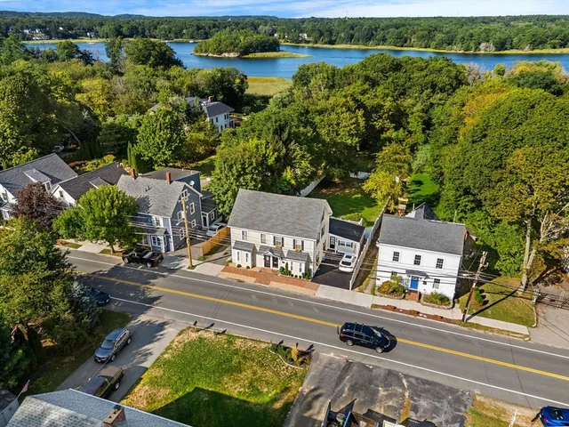 an aerial view of a house with garden space and lake view
