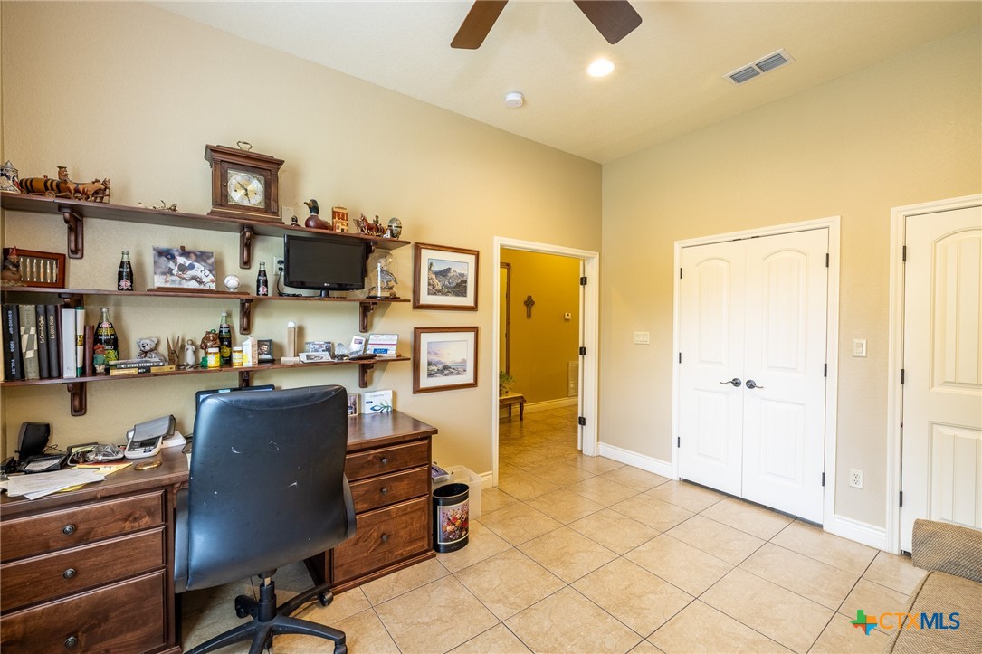 1338 Donovan Street Gonzales, TX 78629 - Photo 13 of 24 a view of kitchen with stainless steel appliances kitchen island granite countertop a refrigerator and a stove top oven