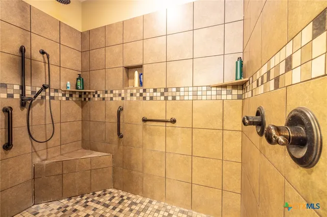 a view of walk in closet with clothes