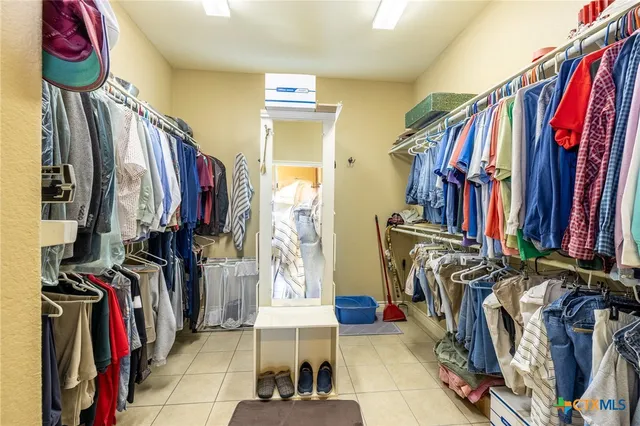 a bathroom with a granite countertop sink mirror and a toilet