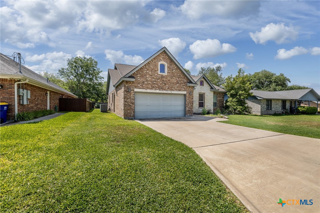 1338 Donovan Street Gonzales, TX 78629 - Photo 2 of 24 a view of a house with a yard and large tree