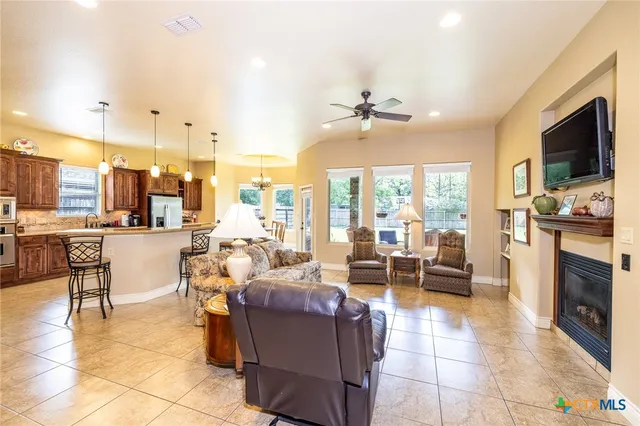 a living room with fireplace furniture and a flat screen tv