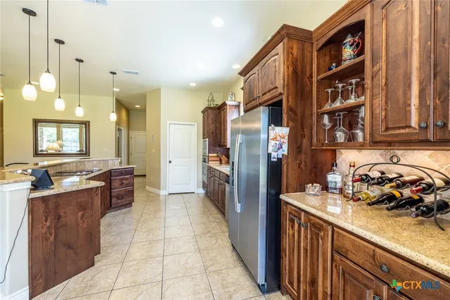 a kitchen with refrigerator and cabinets