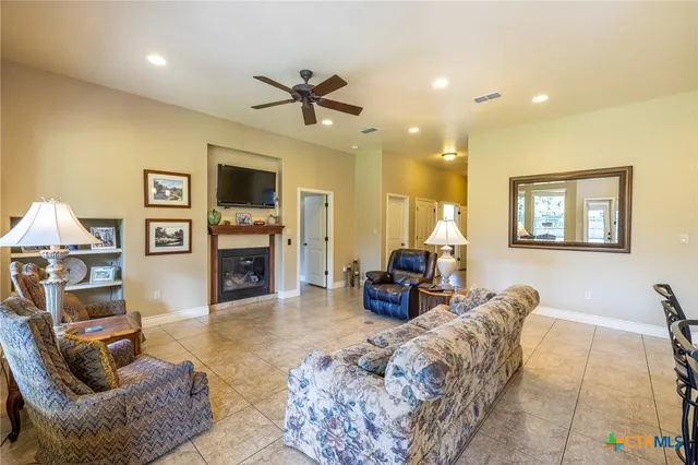a living room with furniture a window and a fireplace