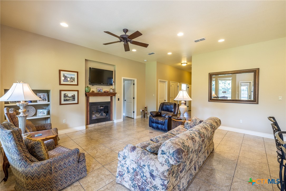 1338 Donovan Street Gonzales, TX 78629 - Photo 9 of 24 a living room with furniture a window and a fireplace