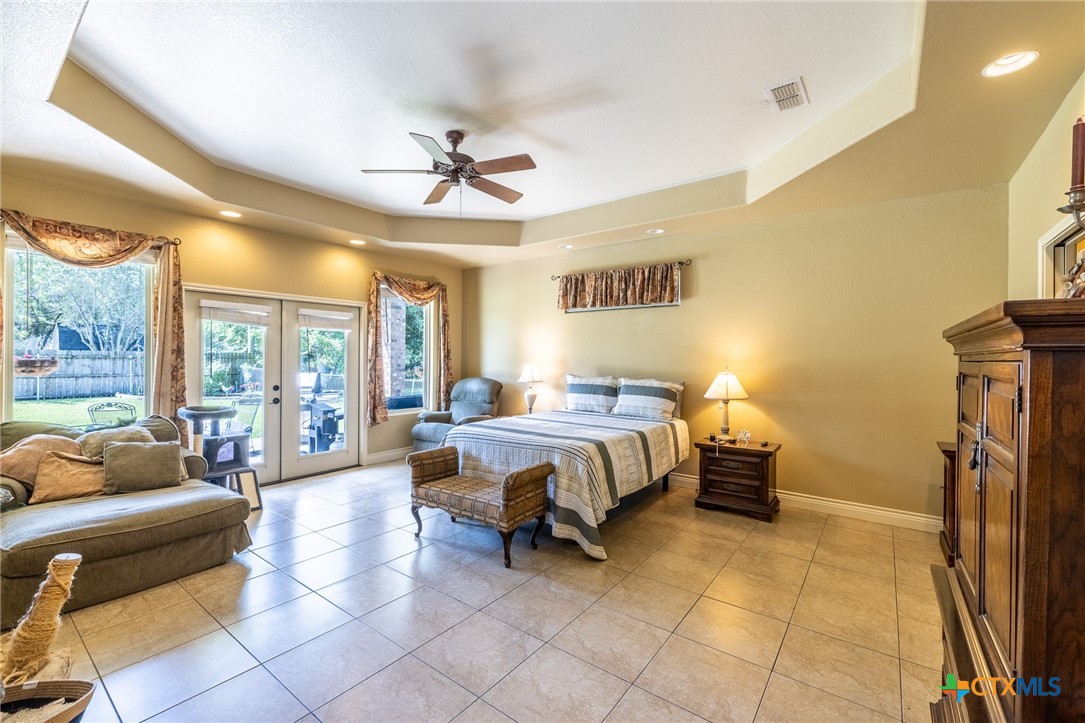 1338 Donovan Street Gonzales, TX 78629 - Photo 10 of 24 a spacious bedroom with a bed and glass walk in closet
