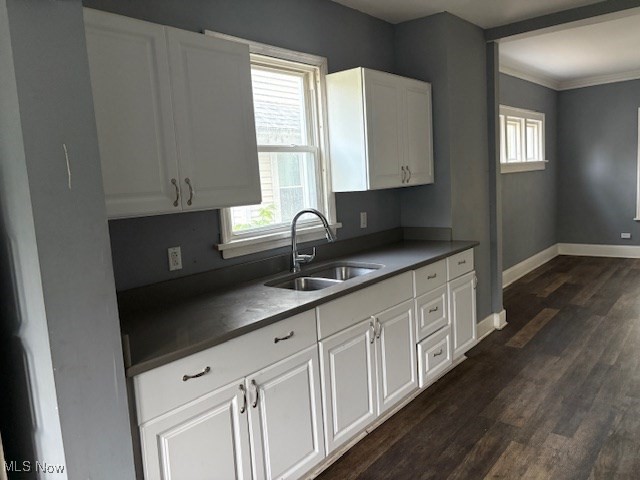 3258 Berkshire Road Cleveland, OH 44118 - Photo 12 of 23 Kitchen featuring dark wood-type flooring, dark countertops, crown molding, and white cabinets