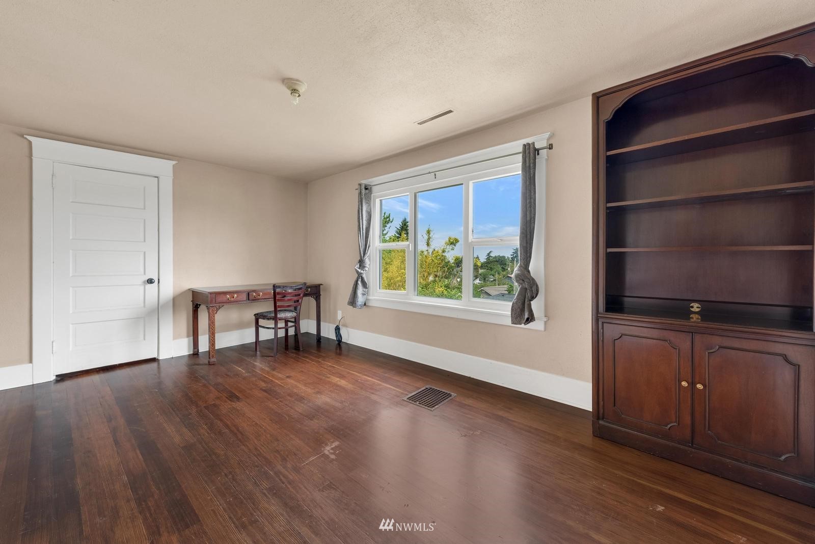 4852 South Orcas Street Seattle, WA 98118 - Photo 16 of 20 a view of an empty room with window and wooden floor
