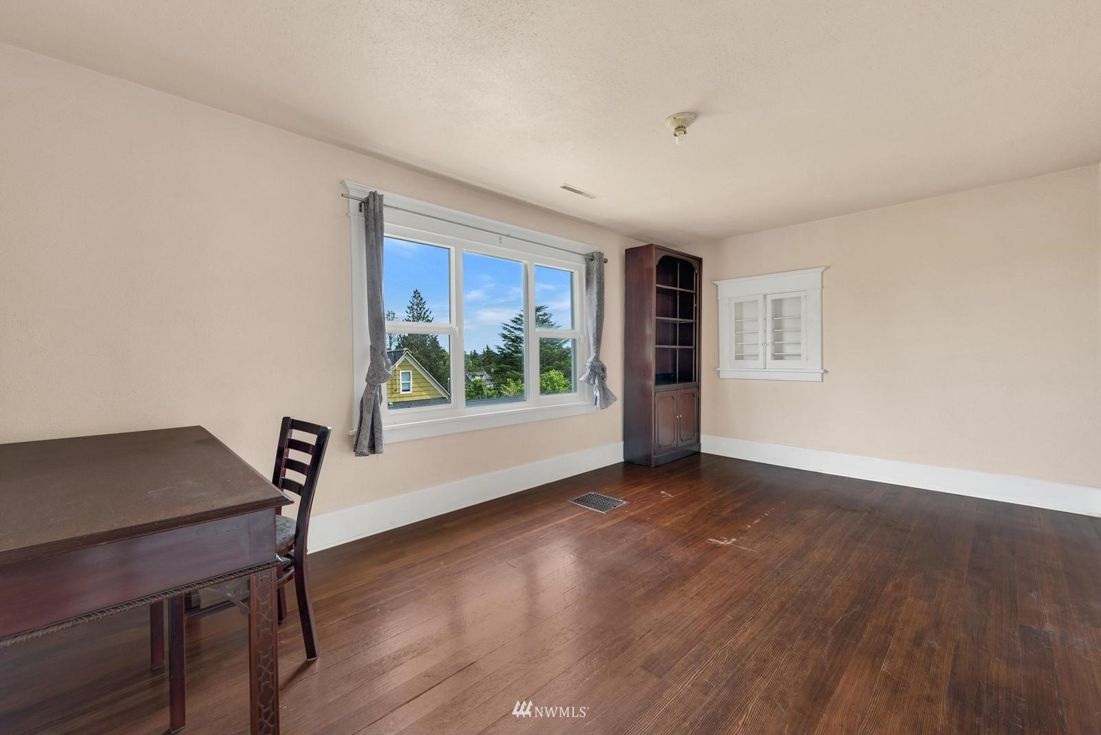 4852 South Orcas Street Seattle, WA 98118 - Photo 17 of 20 a view of room with window and wooden floor